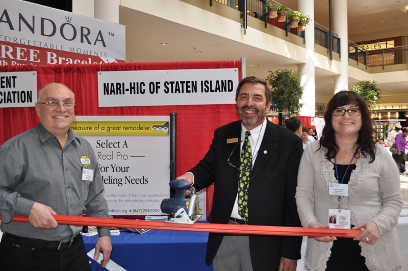 Performing a wood-cutting ceremony to mark the opening in 2012 of the first annual Staten Island Home Improvement Contractors & Remodelers Showcase are: Steve Coppola, chairman of the 2014 home show event, and past president of NARI-HIC of Staten Island; Butch Galante, member and past president, and Lana Ruggiero Seidman, president. 