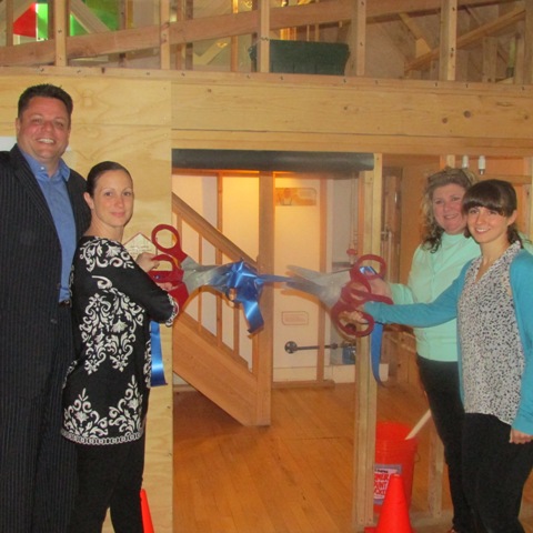 Laird Klein, president of the Staten Island Board of Realtors (SIBOR), and Traci Cangiano, immediate past president of SIBOR, participate in a ribbon-cutting ceremony with Dina Rosenthal, executive director of the Staten Island Children’s Museum, and Renee Wasser, the museums’ exhibits manager. The occasion marked the grand opening of the museum’s newly refurbished House About It exhibit, which SIBOR helped sponsor with a $7,500 donation.