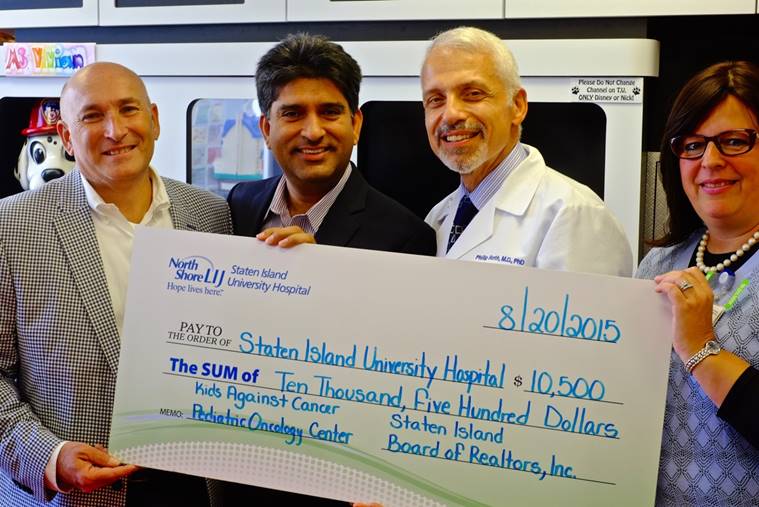 Ron Molcho, a SIBOR director and chairman of the organization’s Realtors’ Challenge Cup golf outing, and Dil Gillani, president of SIBOR, present a check earmarked for the planned Staten Island University Hospital/Kids Against Cancer pediatric-oncology center to Dr. Philip Roth, director of Neonatology and the Department of Pediatrics at SIUH, and Dr. Sarah Vaiselbuh, a pediatric hematology-oncology expert and director of the new wing at the hospital's North campus.