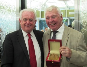 Thomas G. Hyland Jr. holds his newly bestowed William (Bill) Coull Realtor Service Award beside Sandy Krueger, CEO of SIBOR.