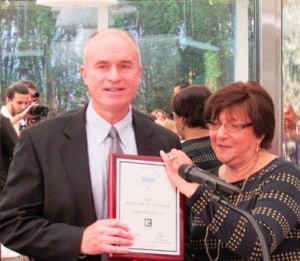 Joseph Runfola accepts the 2015 Realtor of the Year Award from Georgianna Diaz.