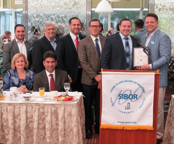 Representatives of Vanguard Funding LLC gather alongside SIBOR Immediate Past President Laird Klein, far right, as their firm is honored with SIBOR’s Affiliate of the Year Award. Accepting the award on behalf of Vanguard Funding, from left, are TJ Bongiorno, Doug Vairo, John Austin, Eric Busuttil and Robert Tuzzo. Seated in the foreground are Claire Bisignano Chesnoff, SIBOR president-elect, and Dilshad (Dil) Gillani, president.